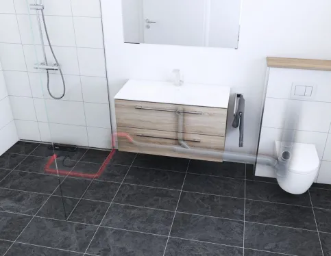Modernisiertes Bad mit Bodenablaufpumpe und Duschrinne CeraWall Connect. Die neue Förderleitung (rot) mündet in der vorhandenen alte Abwasserleitung (grau).